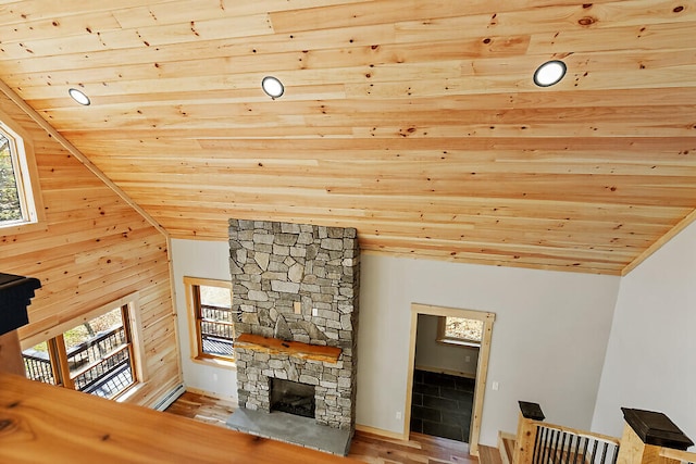 living room featuring a healthy amount of sunlight, wood ceiling, and lofted ceiling