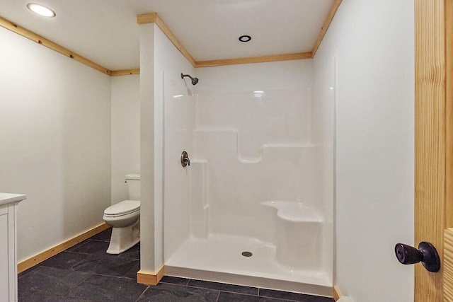 bathroom featuring vanity, toilet, and a shower