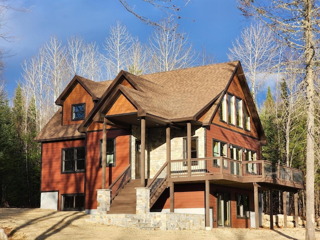 view of front of house with stairs and roof with shingles