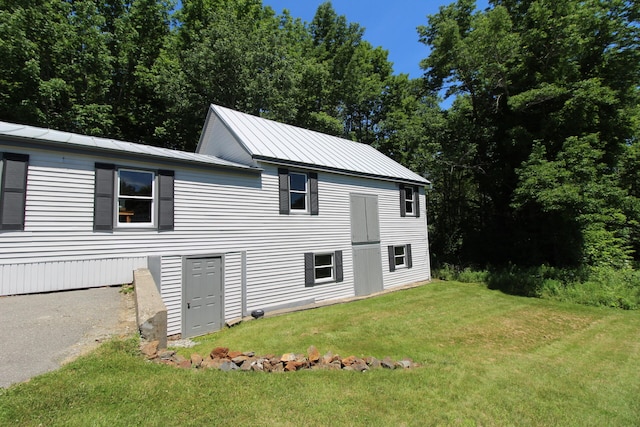 view of property exterior featuring a lawn