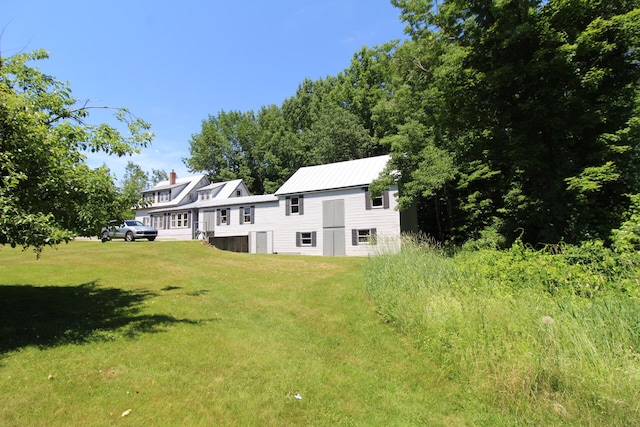 rear view of house featuring a lawn