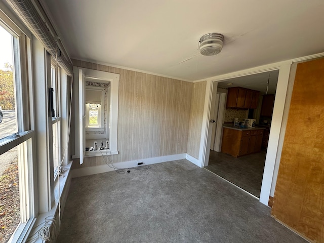 carpeted spare room featuring crown molding