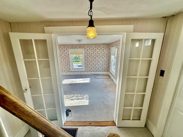 doorway to outside with carpet floors