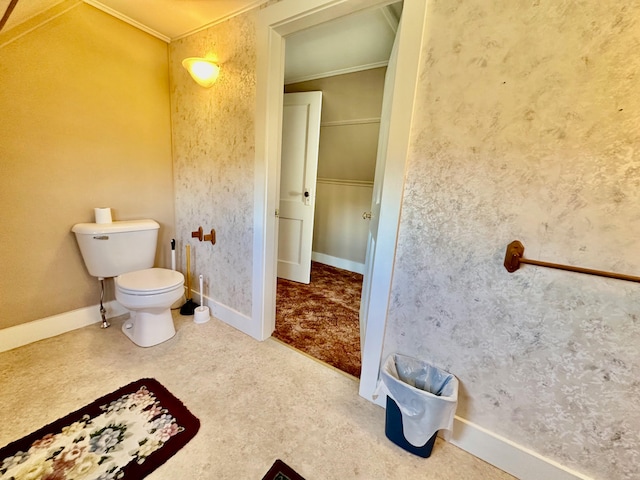 bathroom with crown molding and toilet