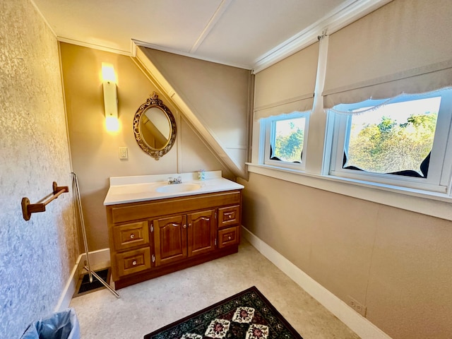 bathroom featuring vanity and ornamental molding