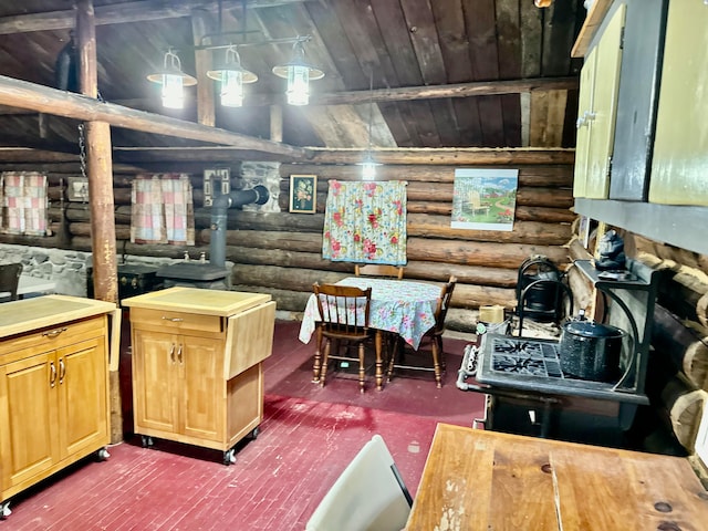 kitchen featuring wooden ceiling, lofted ceiling, and log walls