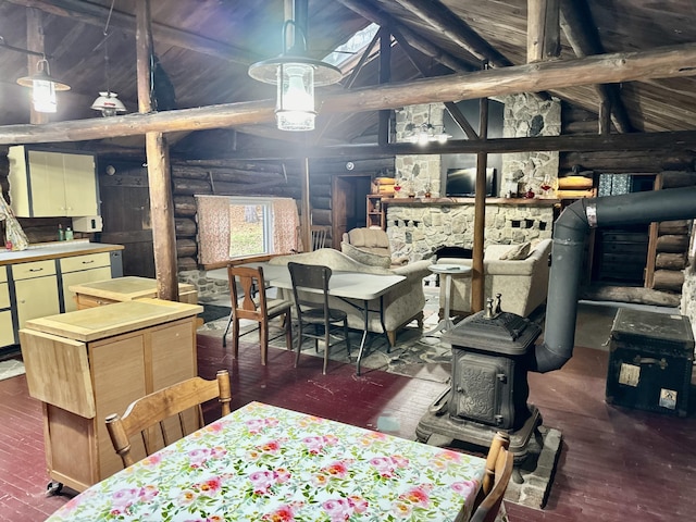 dining space featuring beamed ceiling, wooden walls, dark wood-type flooring, and high vaulted ceiling