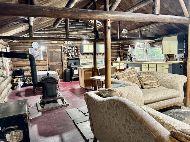 living room featuring log walls, dark hardwood / wood-style floors, beamed ceiling, and a wood stove