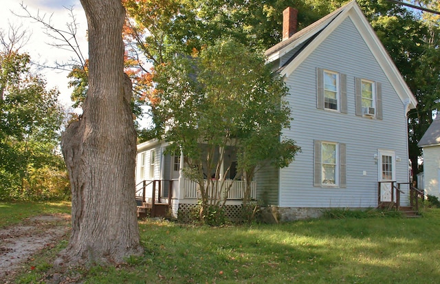 view of side of home featuring cooling unit and a yard