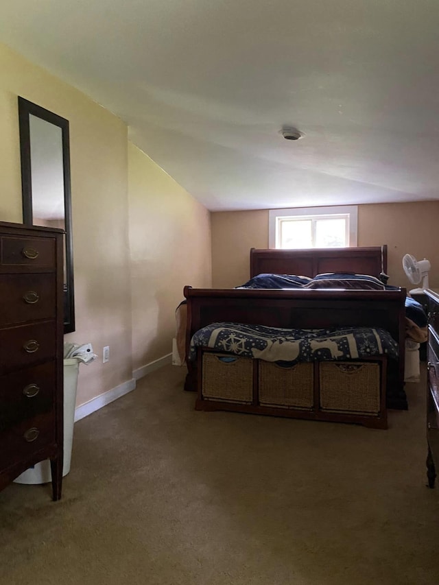 carpeted bedroom featuring lofted ceiling