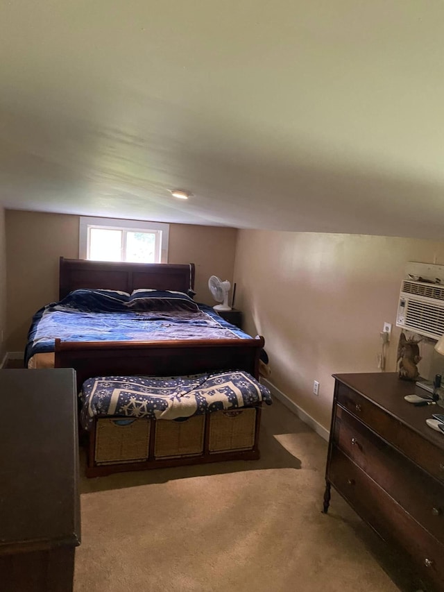 bedroom with light carpet, lofted ceiling, and a wall unit AC