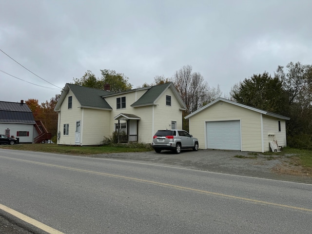 view of front property with a garage and an outbuilding