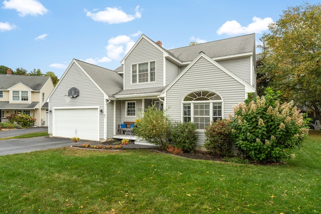 front of property with a front yard and a garage