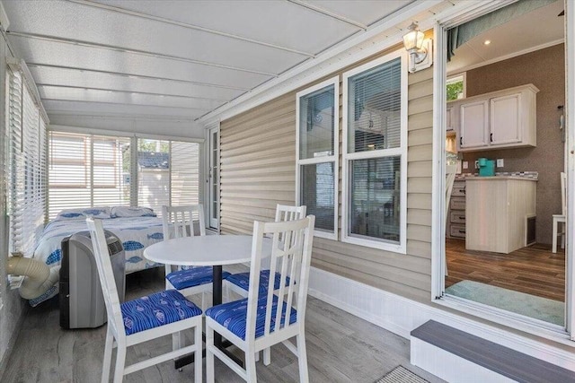 sunroom / solarium featuring vaulted ceiling