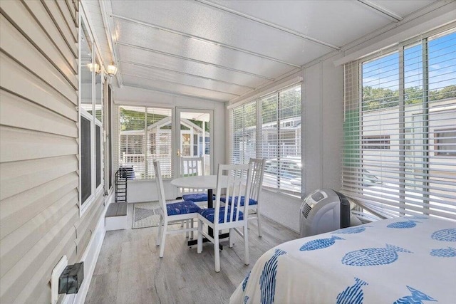 bedroom with wood finished floors and vaulted ceiling