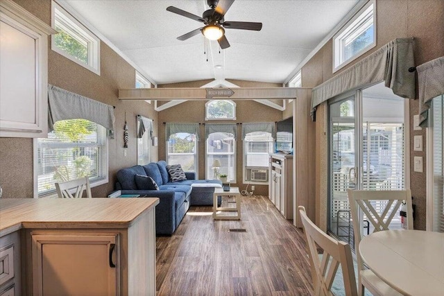 living room with ceiling fan, a textured ceiling, lofted ceiling with beams, and dark hardwood / wood-style flooring