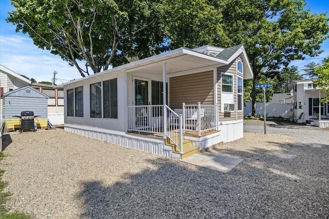 rear view of house with covered porch