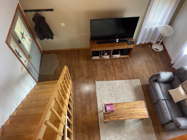 living room featuring wood-type flooring and wood walls