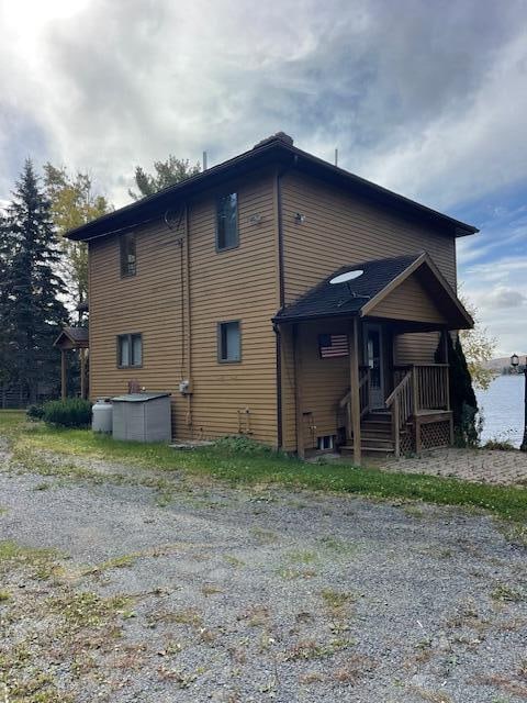 rear view of property featuring covered porch