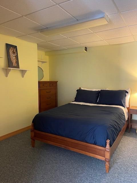 bedroom with carpet and a paneled ceiling