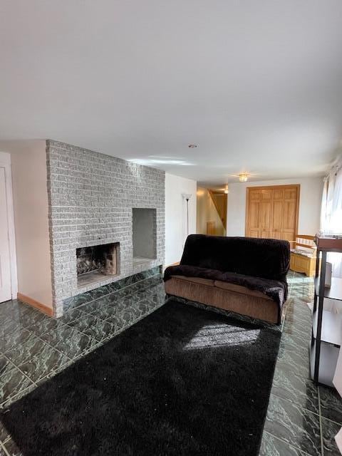 living room featuring a brick fireplace