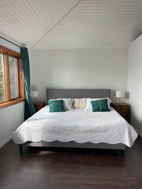 bedroom with dark wood-type flooring