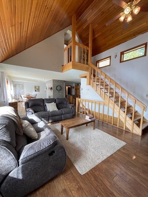 living room featuring wood-type flooring, ceiling fan, high vaulted ceiling, and wooden ceiling