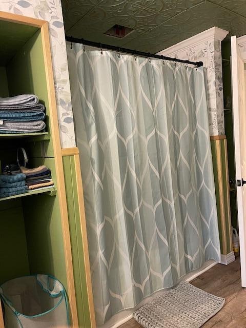 bathroom featuring a shower with curtain and hardwood / wood-style flooring