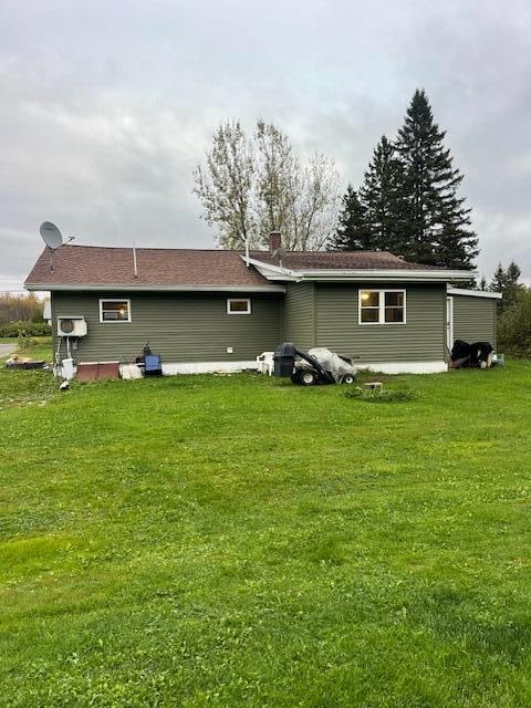 back of house featuring a yard