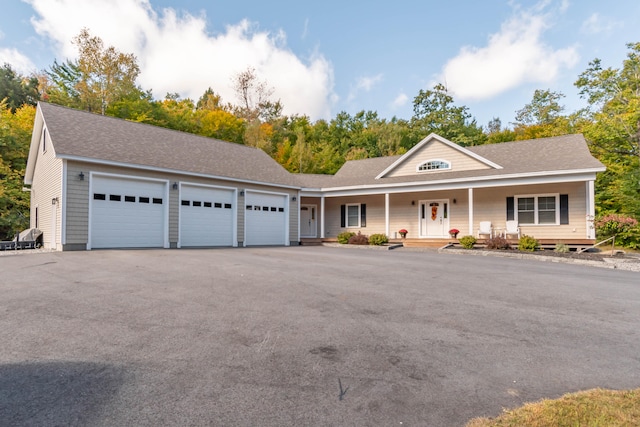 view of front of property featuring a porch and a garage