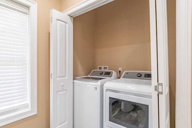 clothes washing area with independent washer and dryer