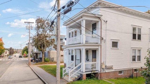 view of side of home featuring a balcony