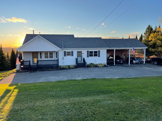 single story home featuring a yard and covered porch