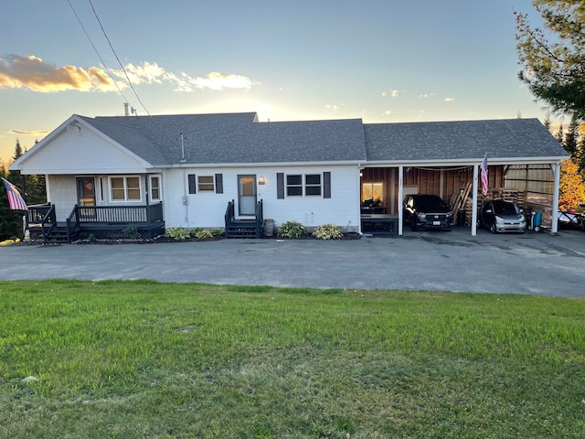 single story home featuring a yard and a carport