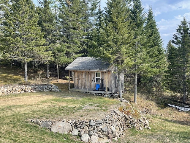 view of outdoor structure featuring a lawn