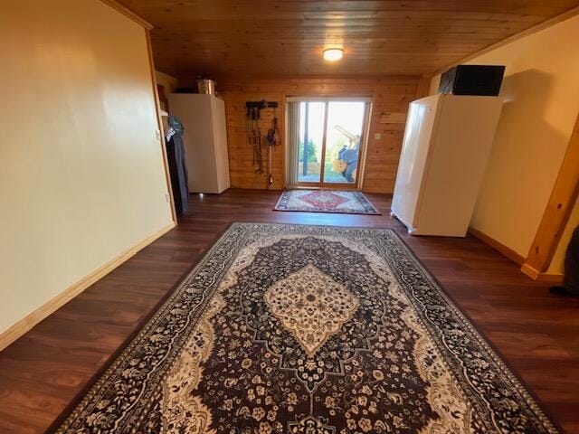 entryway with dark wood-type flooring, wood walls, and wooden ceiling