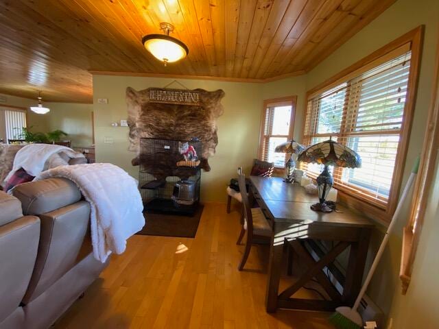 dining space with crown molding, wood ceiling, and light hardwood / wood-style flooring