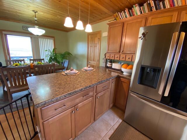 kitchen with wood ceiling, stainless steel fridge, pendant lighting, ornamental molding, and light tile patterned floors