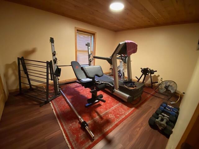 exercise area with dark wood-type flooring and wood ceiling