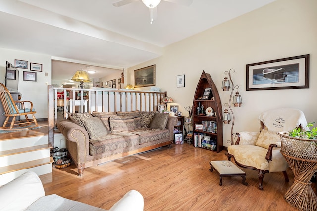 living room featuring hardwood / wood-style floors and ceiling fan