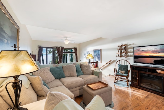 living room featuring light wood-type flooring and ceiling fan