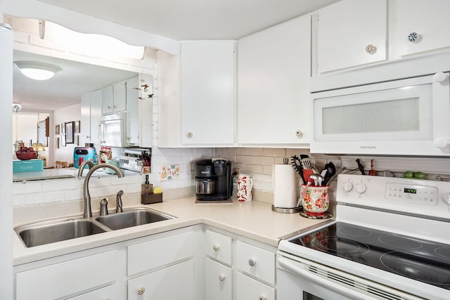 kitchen featuring white cabinets, decorative backsplash, white appliances, and sink