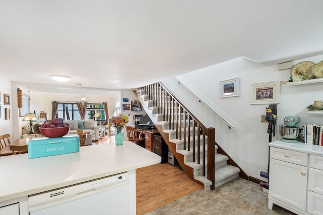 kitchen featuring ceiling fan, dishwasher, and white cabinets