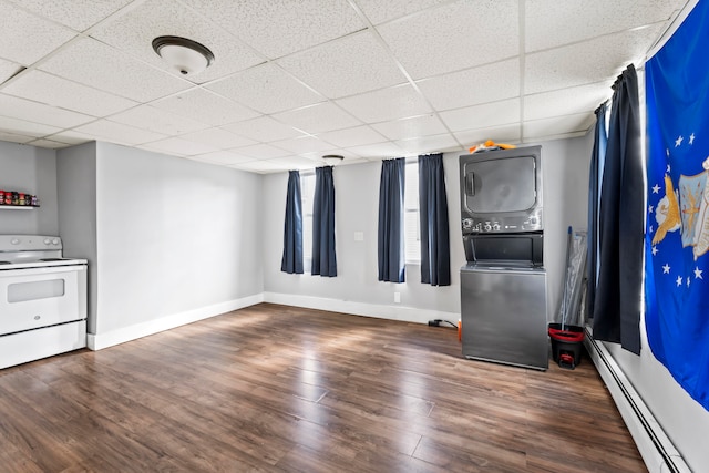 interior space with a drop ceiling, a baseboard heating unit, and dark wood-type flooring