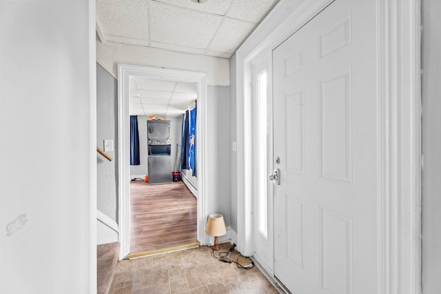 foyer entrance with a drop ceiling, light hardwood / wood-style floors, and a healthy amount of sunlight