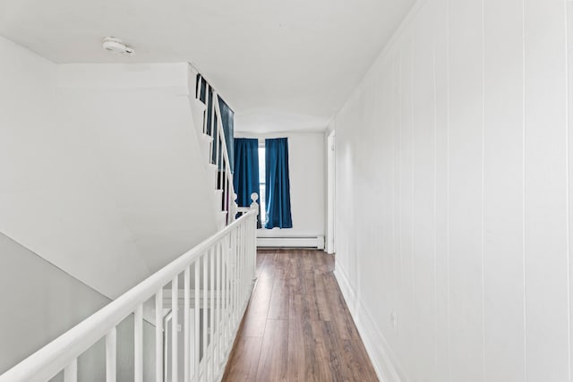 corridor featuring dark hardwood / wood-style floors and a baseboard heating unit