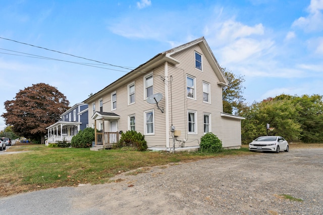 view of side of property with a lawn