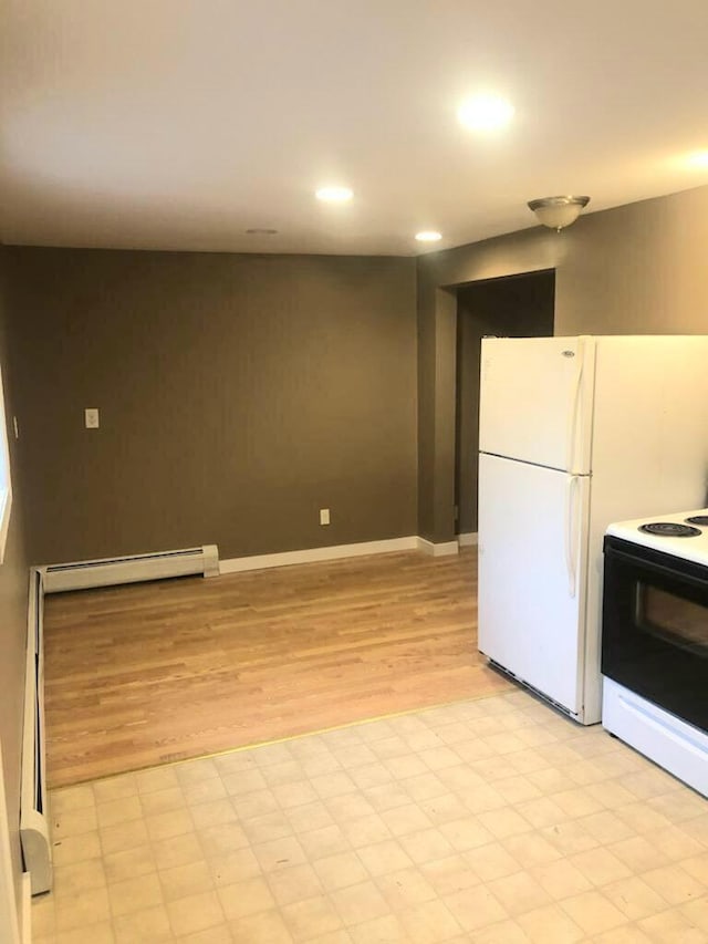 kitchen with light hardwood / wood-style flooring, white appliances, and baseboard heating