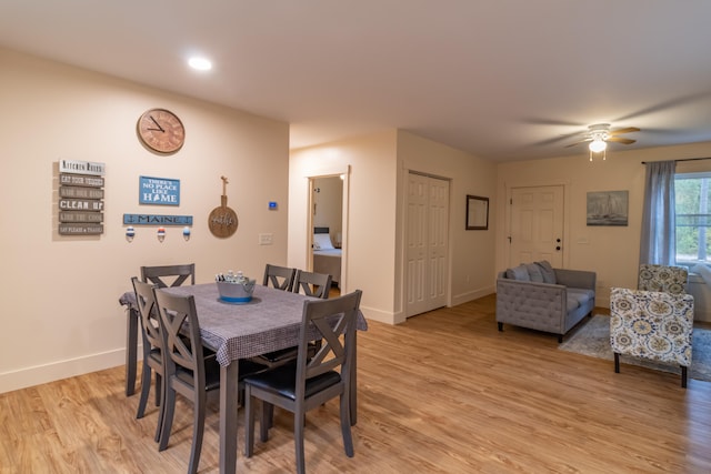 dining area with light wood-type flooring and ceiling fan