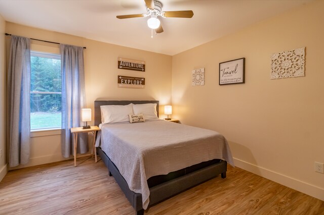 bedroom with light hardwood / wood-style flooring and ceiling fan